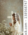 Young girl praying in lace veil for first communion portrait with cross and floral arrangement for invitation or card design. Copy space 138568747
