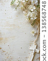 White floral arrangement with rosary and crucifix on distressed wood background for first communion invitation and card design. Copy space. Frame for wedding or birthday. Happy Easter 138568748
