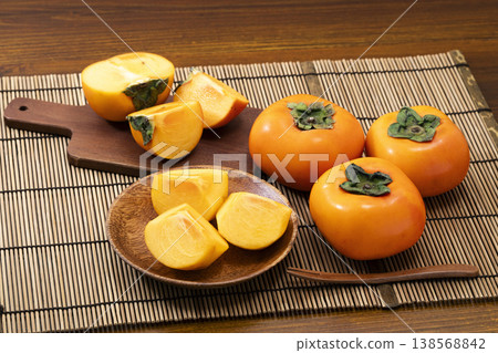 Persimmons in a colander Persimmons in a colander 138568842