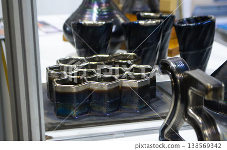Object printing on 3D printer from melting metal thread. Model different shape printed on 3D printer from filament of molten metal. 3D printing modeling manufacturing technology Additive progressive 138569342