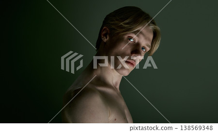 Young man with direct gaze and clean skin in soft controlled studio lighting. Young man with direct gaze and clean skin in soft controlled studio lighting. 138569348