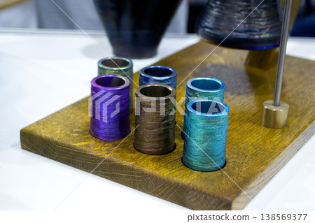 Object printing on 3D printer from melting metal thread. Model round shape printed on 3D printer from filament of molten metal. New 3D printing modeling manufacturing technology. Additive progressive Object printing on 3D printer from melting metal thread. Model round shape printed on 3D printer from filament of molten metal. New 3D printing modeling manufacturing technology. Additive progressive 138569377