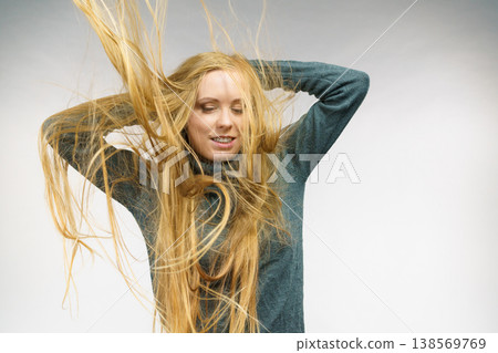 Girl with hair flying around her face Girl with hair flying around her face 138569769