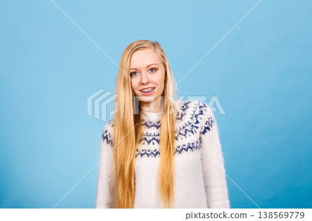 Happy woman showing her braces on teeth Happy woman showing her braces on teeth 138569779