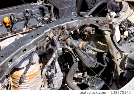 Mechanic is working on car engine in garage engine is open parts are removed for repair. Mechanic is working on car engine in garage engine is open parts are removed for repair. 138570143