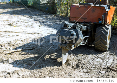 Small garden tiller works on turning over soil it is useful for breaking up dirt to make it ready for planting. Small garden tiller works on turning over soil it is useful for breaking up dirt to make it ready for planting. 138570149