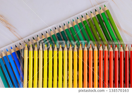 Pencils in various colors are lined up neatly they are ready for use in art coloring activities. Pencils in various colors are lined up neatly they are ready for use in art coloring activities. 138570163