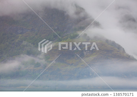 Misty mountains and fjord in Norway Misty mountains and fjord in Norway 138570171