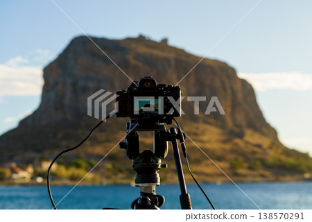 Camera on tripod and Monemvasia island 138570291