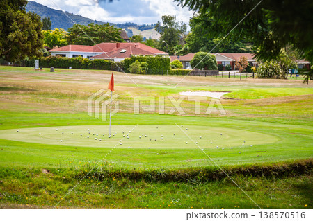 Golf practice green with scattered balls Golf practice green with scattered balls 138570516