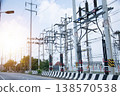 Electricity transmission towers line the side of the road. 138570538
