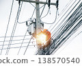 An electrician is working on a power pole. 138570540