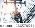 An electrician is working on a power pole. 138570541