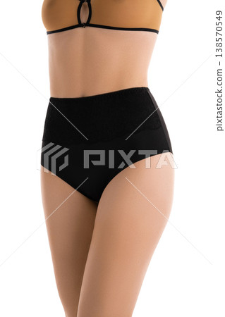 Woman's torso in elegant black high waisted panties and beige bra on white background 138570549