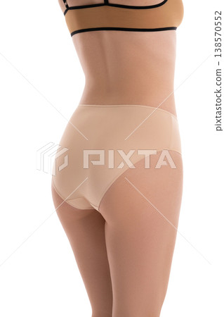 Rear view of a fit woman in seamless beige underwear isolated on a white background 138570552