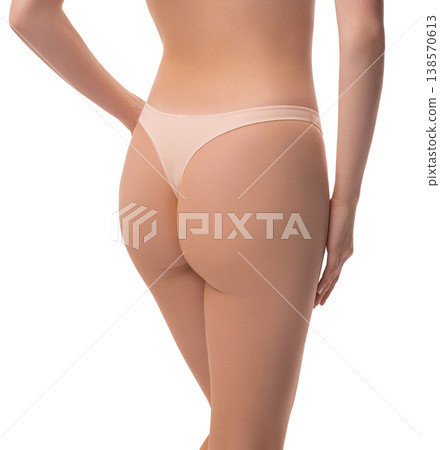 Woman's toned buttocks and slim waist in beige underwear. Rear view isolated on white Woman's toned buttocks and slim waist in beige underwear. Rear view isolated on white 138570613