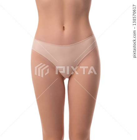 Slender woman with fit stomach and hips wearing beige underwear isolated on white Slender woman with fit stomach and hips wearing beige underwear isolated on white 138570617
