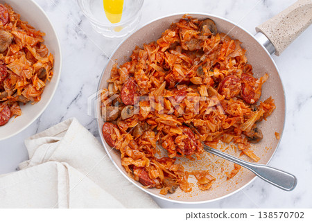 Bigos, Polish dish bigos, on the table, pan with stewed meat, with cabbage, chorizo sausages, mushrooms, homemade, without people, 138570702