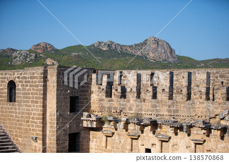 Part of the stone wall of the ancient amphitheater with architectural elements. 138570868
