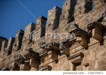 Part of the stone wall of the ancient amphitheater with architectural elements. Part of the stone wall of the ancient amphitheater with architectural elements. 138570871