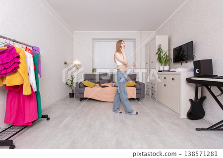 A young woman walks tall with a mobile phone. 138571281