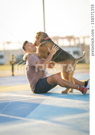 Man playing with dog receiving happy licks Man playing with dog receiving happy licks 138571358