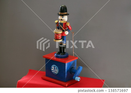 This skillfully crafted wooden drummer figurine is presented in vibrant, saturated colors. 138571697