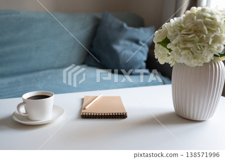 Coffee notebook and flowers on table cozy workspace Coffee notebook and flowers on table cozy workspace 138571996