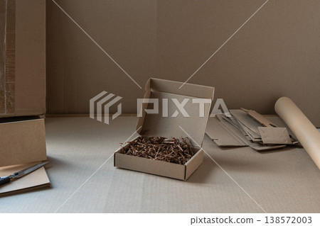 Cardboard packaging box with filler small business shipping concept Cardboard packaging box with filler small business shipping concept 138572003