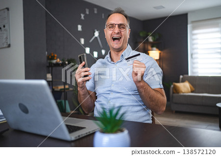 Middle aged Caucasian man online shopping at home Middle aged Caucasian man online shopping at home 138572120
