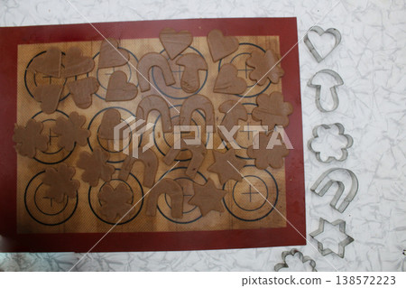 Raw biscuits on a silicone mat. Top view. Raw biscuits on a silicone mat. Top view. 138572223
