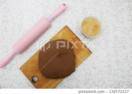 Rolling out the dough for gingerbread cookies. Concept of homemade baking. Rolling out the dough for gingerbread cookies. Concept of homemade baking. 138572227