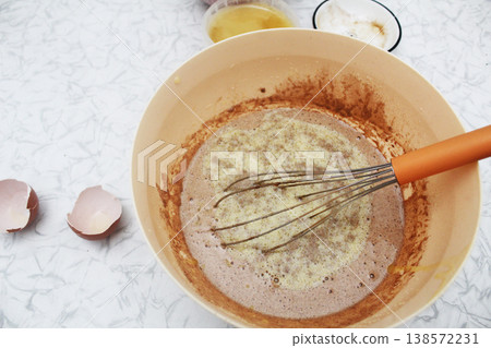 adding melted butter to the dough. Top view. adding melted butter to the dough. Top view. 138572231