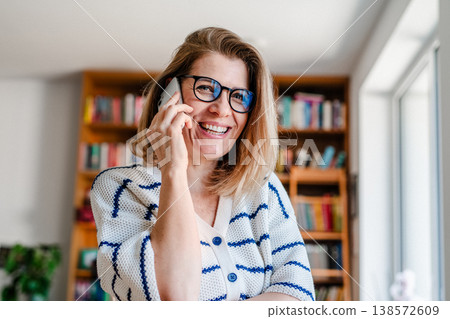 Woman making phone call at home. Woman making phone call at home. 138572609