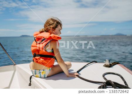 Girl on boat during tropical family vacation. Girl on boat during tropical family vacation. 138572642