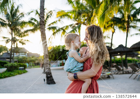 Mother with little daughter in tropical beach resort. 138572644
