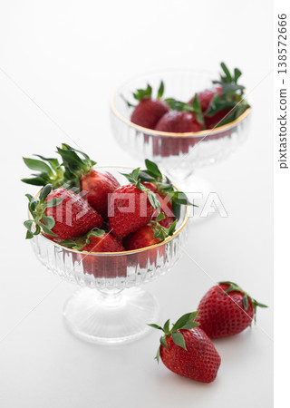 Summer Strawberries in Elegant Glass Bowls on White Table Summer Strawberries in Elegant Glass Bowls on White Table 138572666