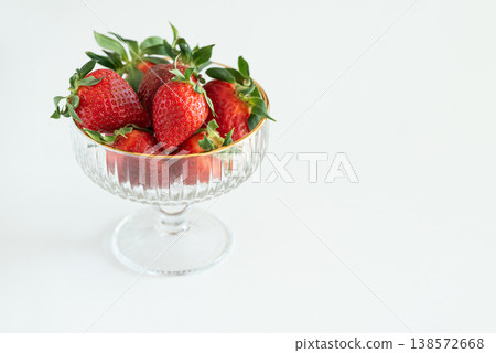 Summer Strawberries in Elegant Glass Bowls on White Table Summer Strawberries in Elegant Glass Bowls on White Table 138572668