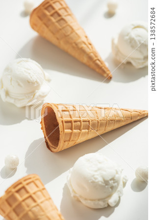 Vanilla Ice Cream Cones with Scoops on White Table Vanilla Ice Cream Cones with Scoops on White Table 138572684