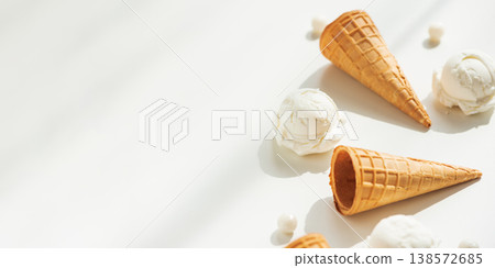 Vanilla Ice Cream Cones with Scoops on White Table Vanilla Ice Cream Cones with Scoops on White Table 138572685