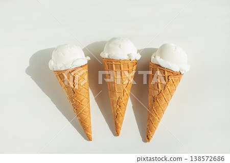 Vanilla Ice Cream Cones with Scoops on White Table Vanilla Ice Cream Cones with Scoops on White Table 138572686