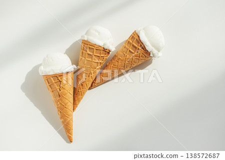 Vanilla Ice Cream Cones with Scoops on White Table Vanilla Ice Cream Cones with Scoops on White Table 138572687
