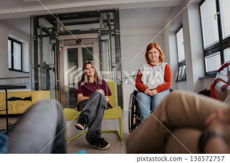 Teen students talking together in inclusive school setting. 138572757
