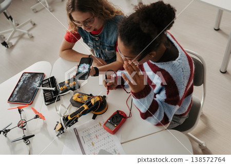 High school students working on robotics project. Girls in STEM. 138572764