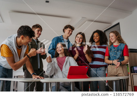Teen students learning together with digital tablet in modern classroom. Teen students learning together with digital tablet in modern classroom. 138572769