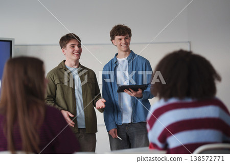 Teen student listening attentively during class with a digital tablet. Teen student listening attentively during class with a digital tablet. 138572771