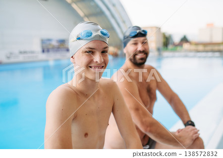 Father and teenage son enjoying swim training together. 138572832