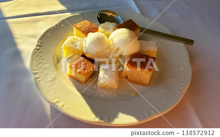 a few slices of plain cake and scoops of vanilla ice cream 138572912
