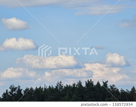 A hill with a view of mountains, trees, blue sky with clouds, bright sky, and cool breeze A hill with a view of mountains, trees, blue sky with clouds, bright sky, and cool breeze 138572934