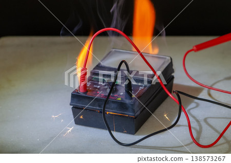 Multimeter fire with wires flame sparks and smoke during emergency situation Multimeter fire with wires flame sparks and smoke during emergency situation 138573267